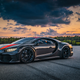 A photo of a black and orange Bugatti Chiron hypercar.